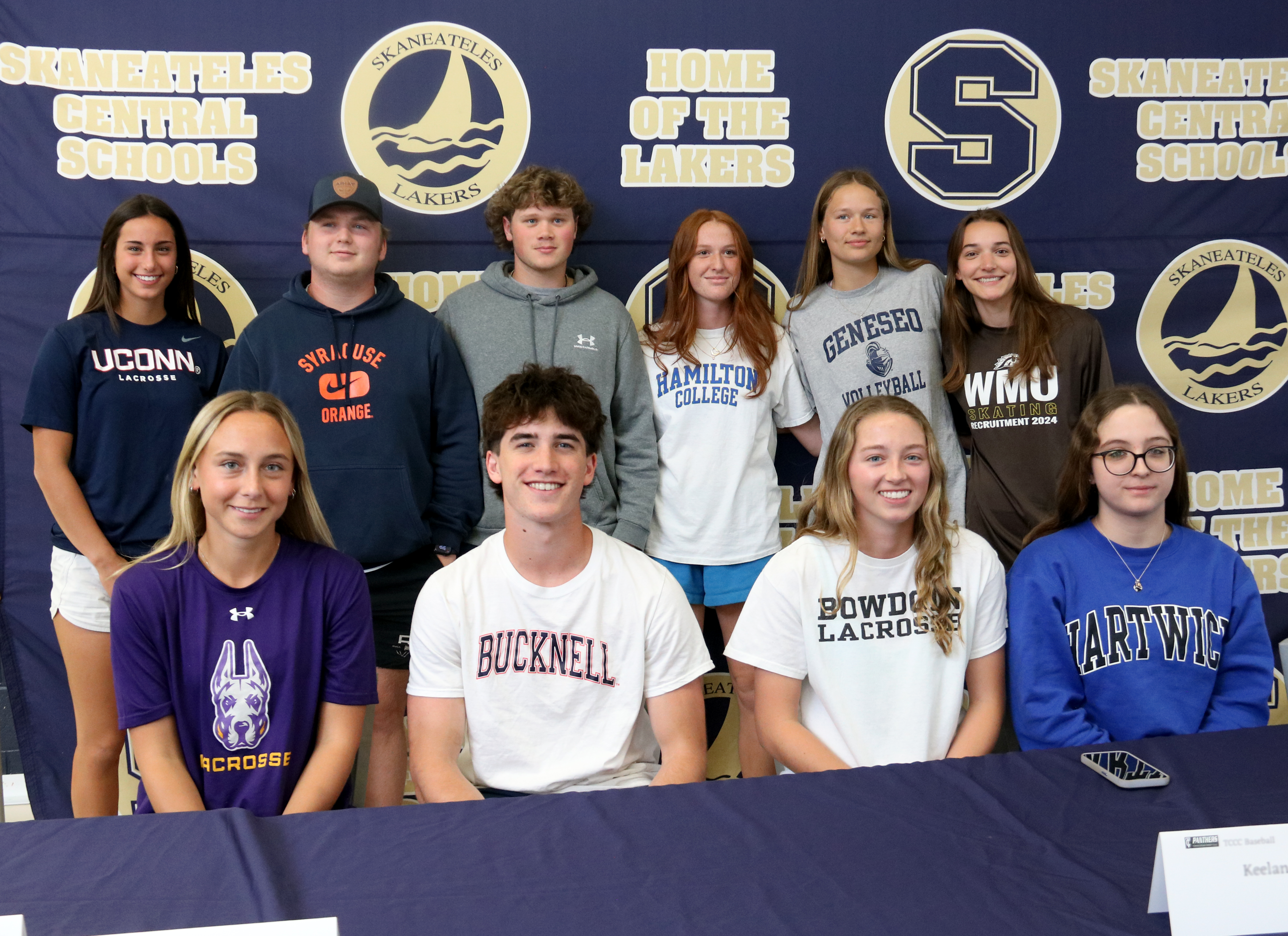 Students are recognized at a ceremony for signing letters to play sports at the collegiate level